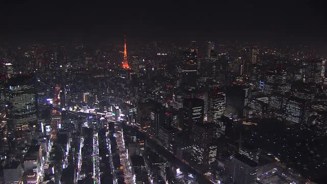Aerial Metropolis illuminated skyscrapers Tokyo Tower Business District Japan