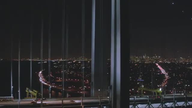 CLOSE UP to WIDE AERIAL of Verrazano Bridge with City background