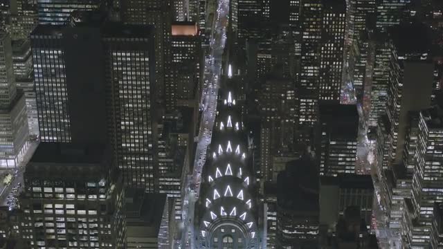 MEDIUM to OVERHEAD POV AERIAL Chrysler Building