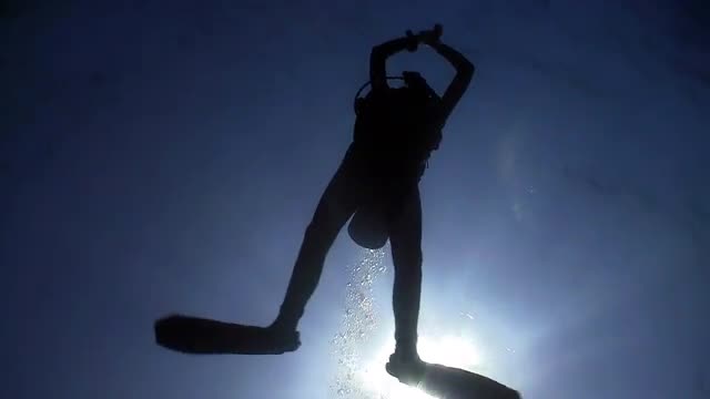 Diver swims over camera. Red sea