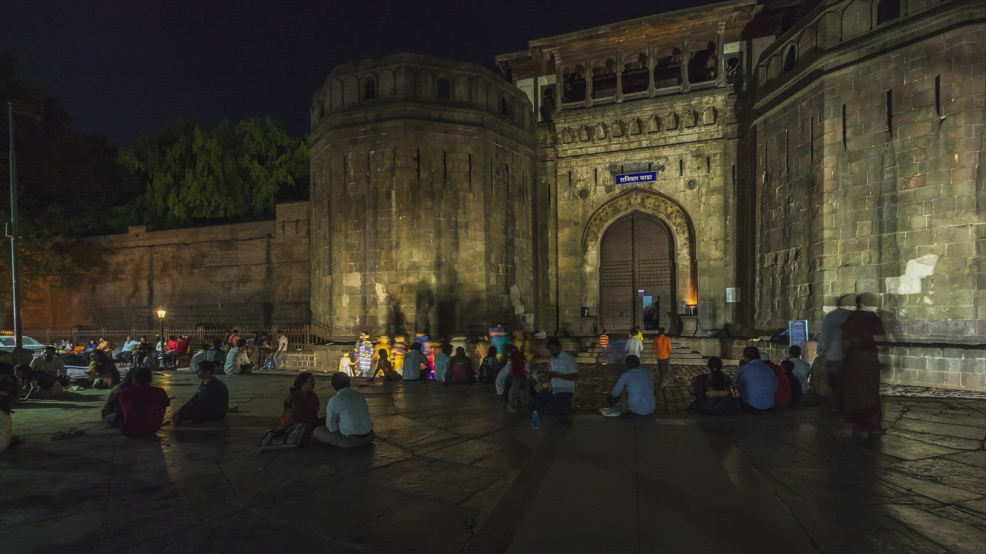Panning Motion Time Lapse of Tourists Visiting Shaniwar Wada at Night in City of Pune, India