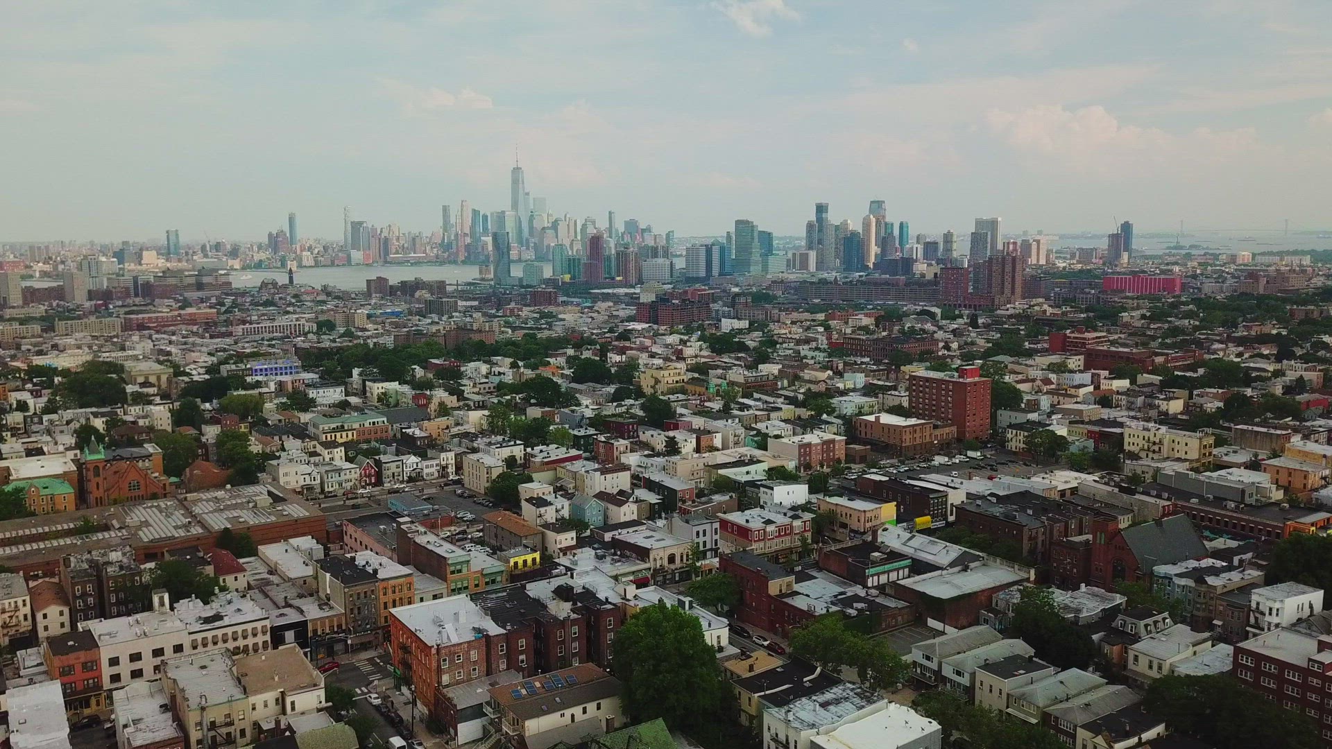 Aerial View of Jersey City Skyline and New York City Skyline - Panning Shot