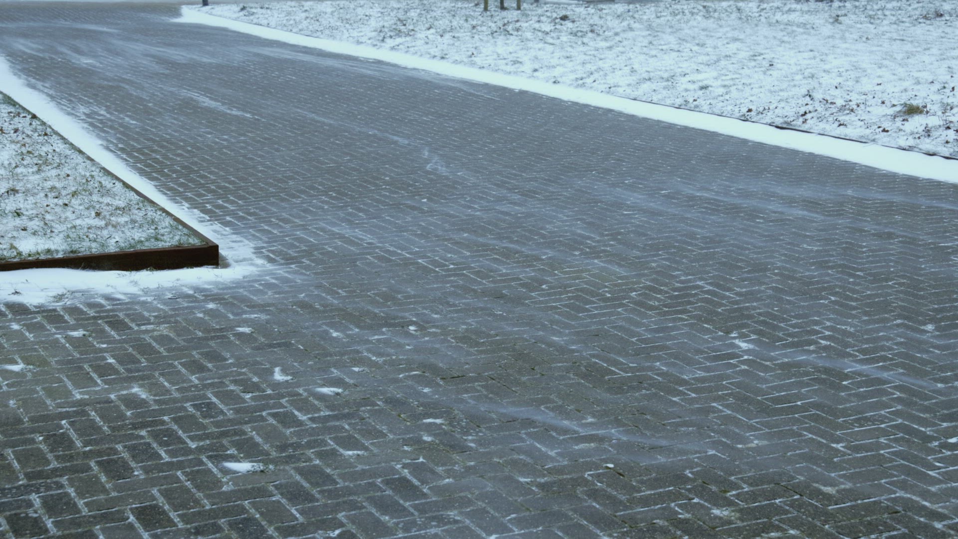 Wind blowing snow on sidewalk, IJlst, Friesland, Netherlands