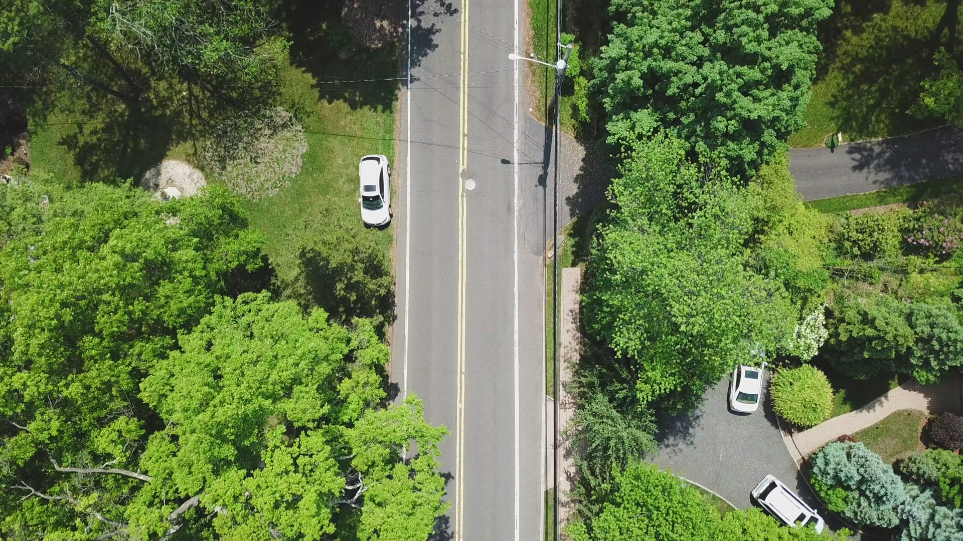 Bird's Eye View of Moving Cars on a Suburban Country Road