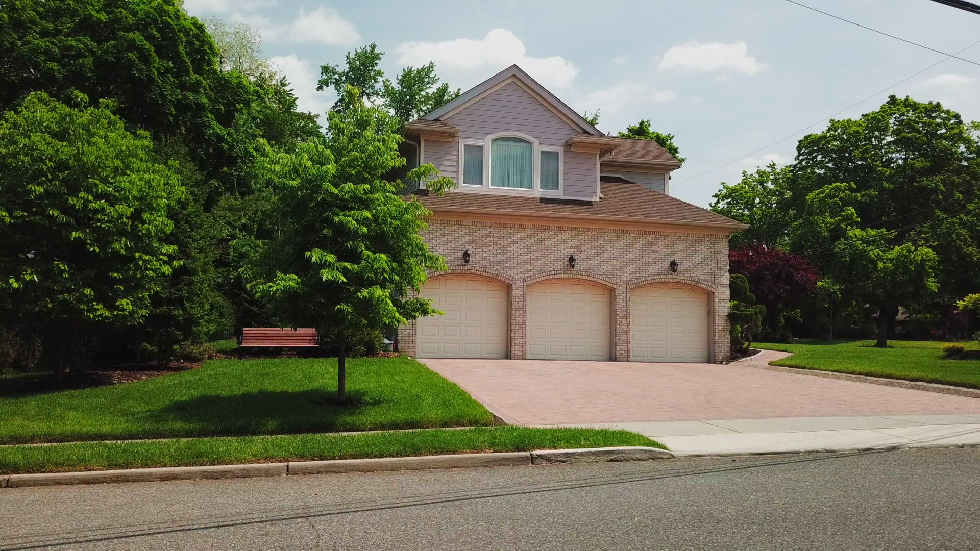 Slider Shot of a Luxury Home's Driveway and Three Car Garage