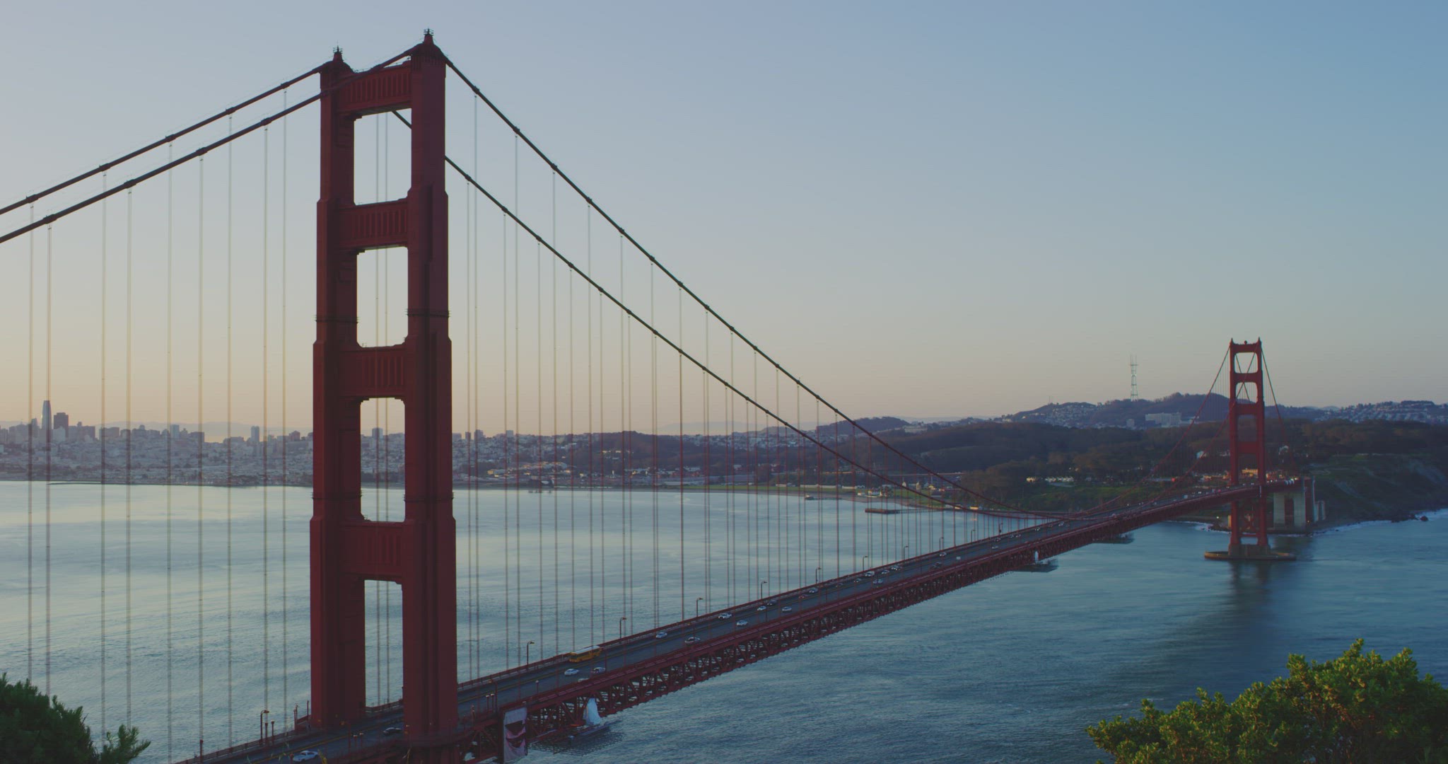 Wide shot of Golden Gate Bridge at sunrise