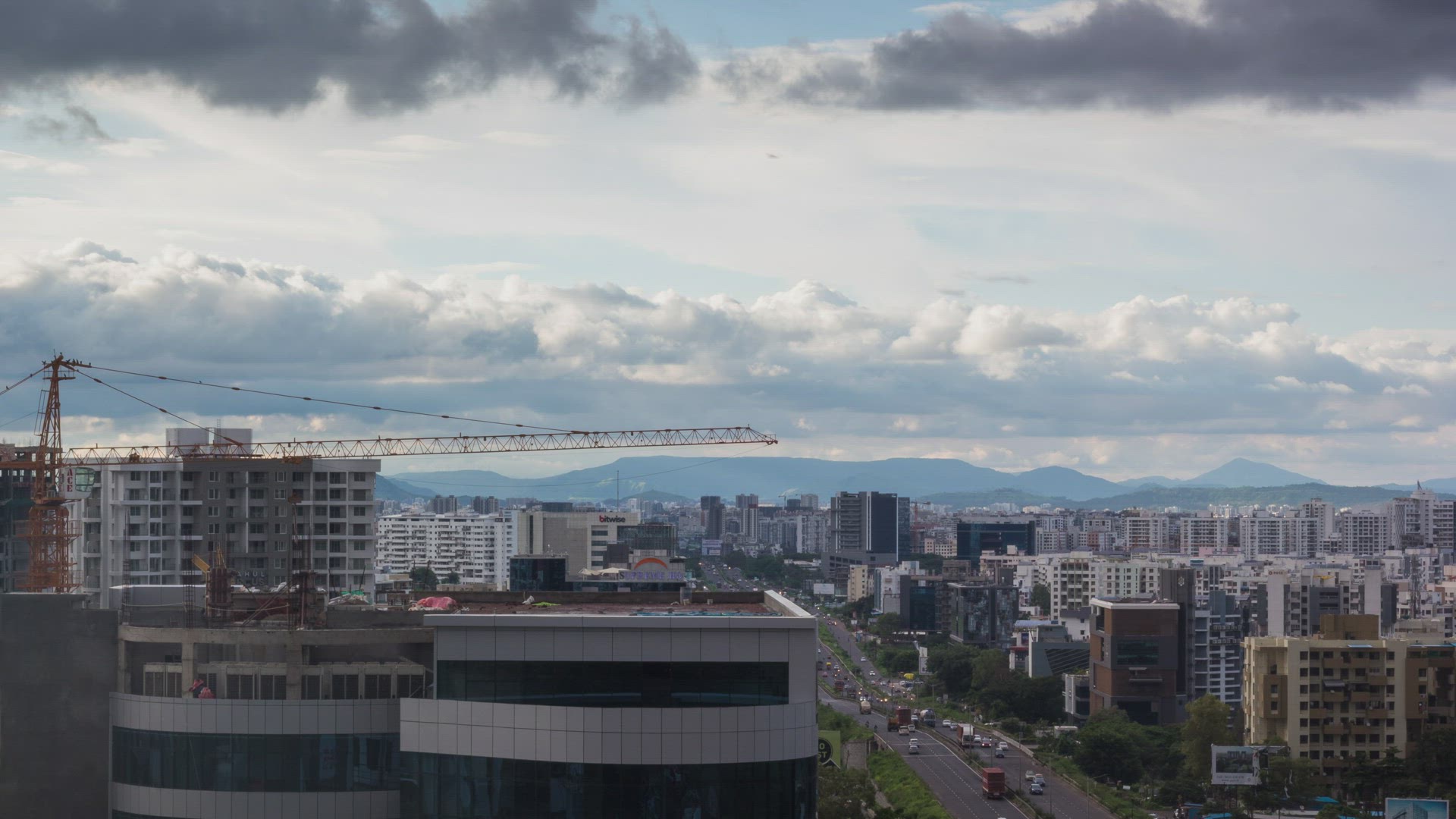 Clouds Passing over the City &amp; Time Lapse of Daytime Traffic on Mumbai-Pune National Highway, In