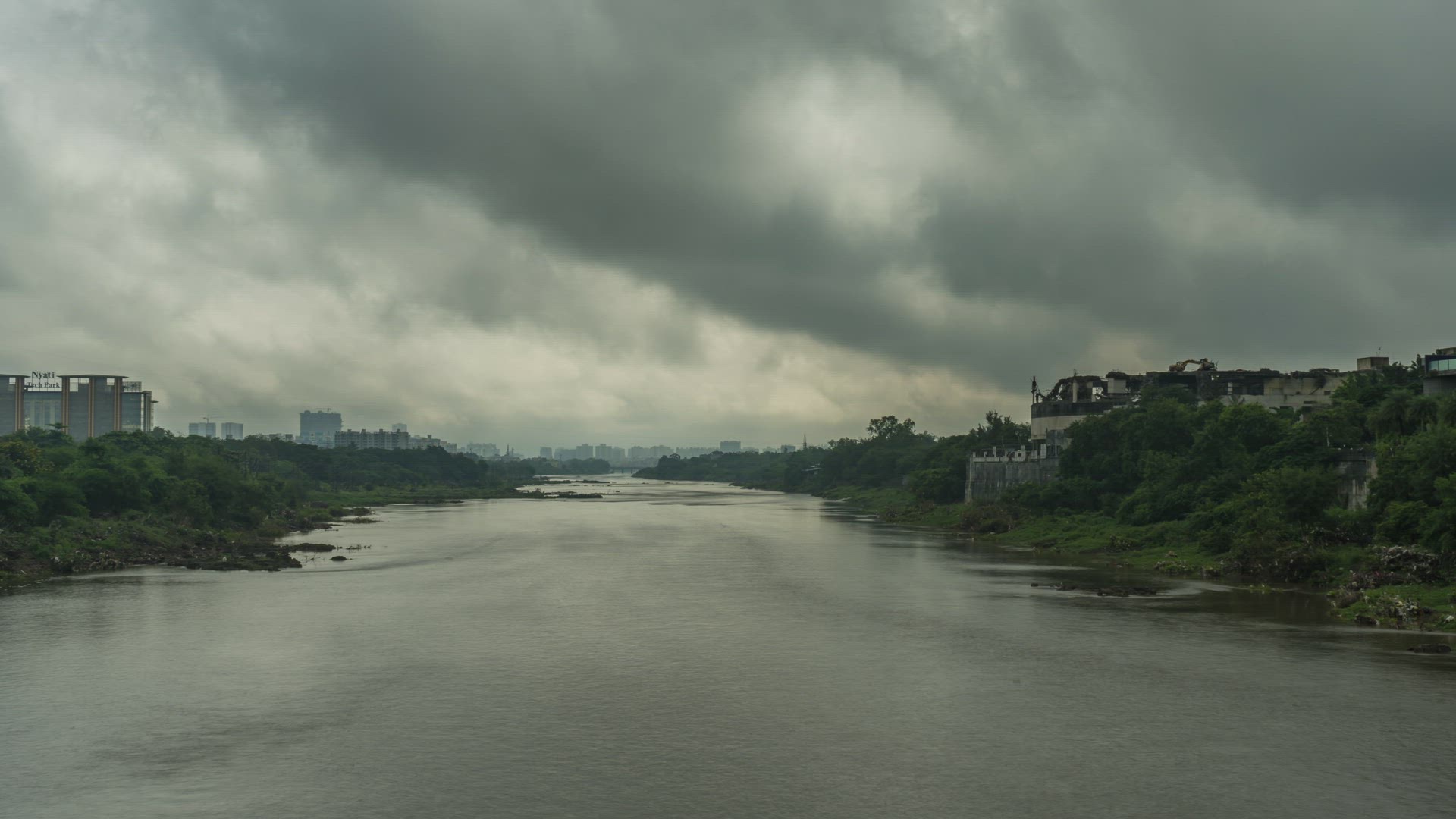 Rainy Clouds Passing over the River passing through the City of Pune, Maharashtra, India