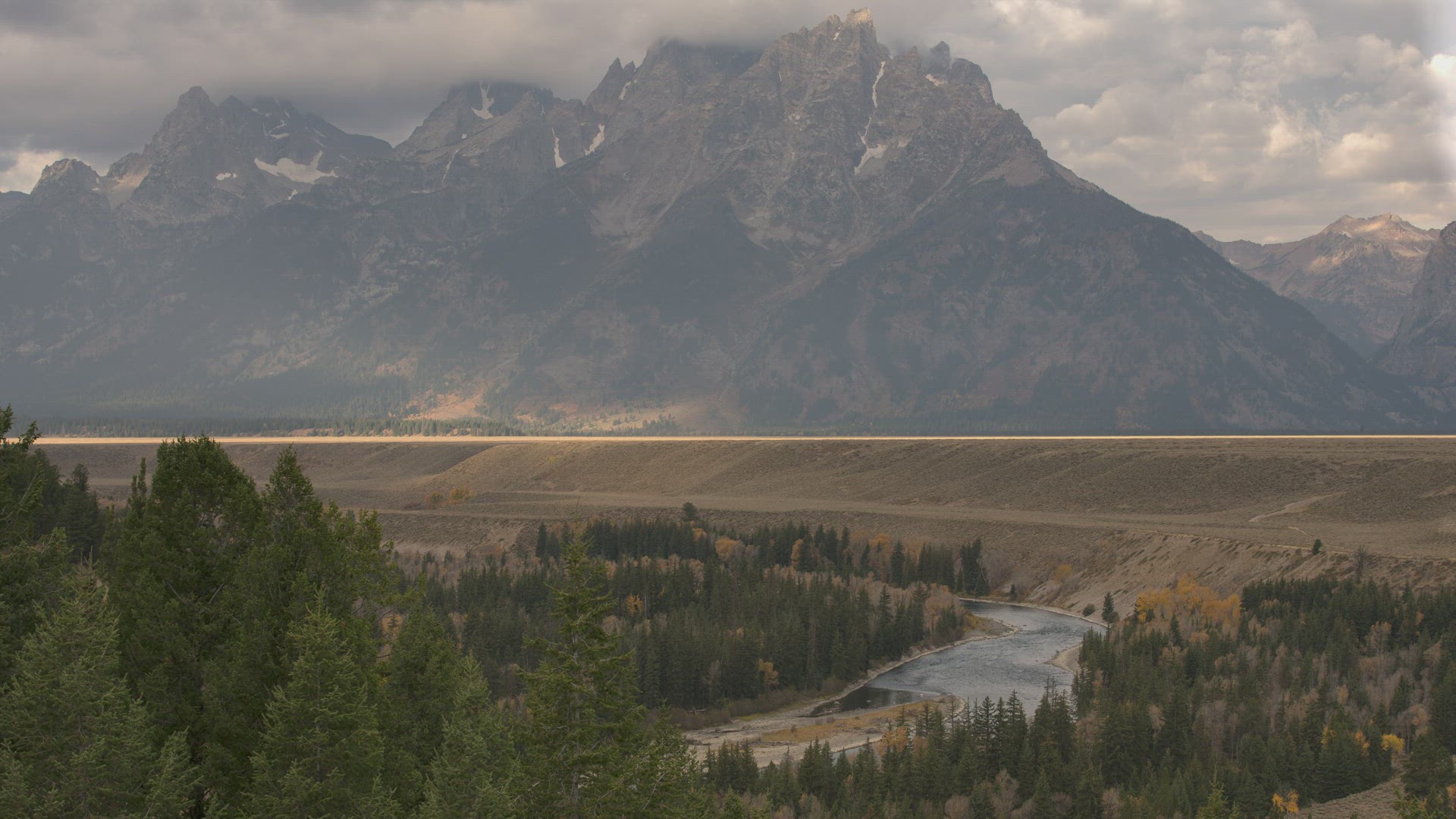 Grand Teton National Park Timelapes, Clouds passing over Grand Range with sun rolling through fields