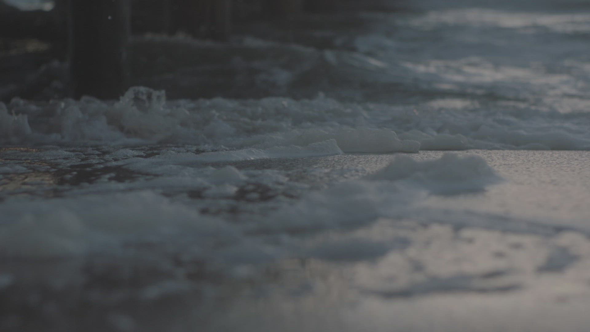 Waves on beach near pier
