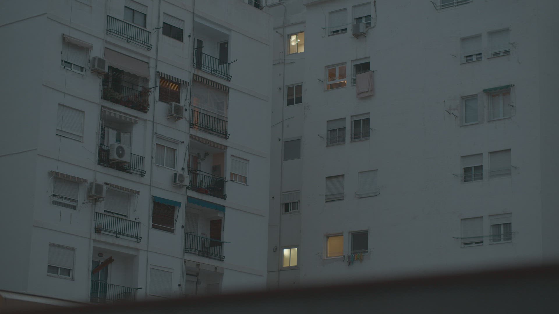 White facade apartment house, view in the evening