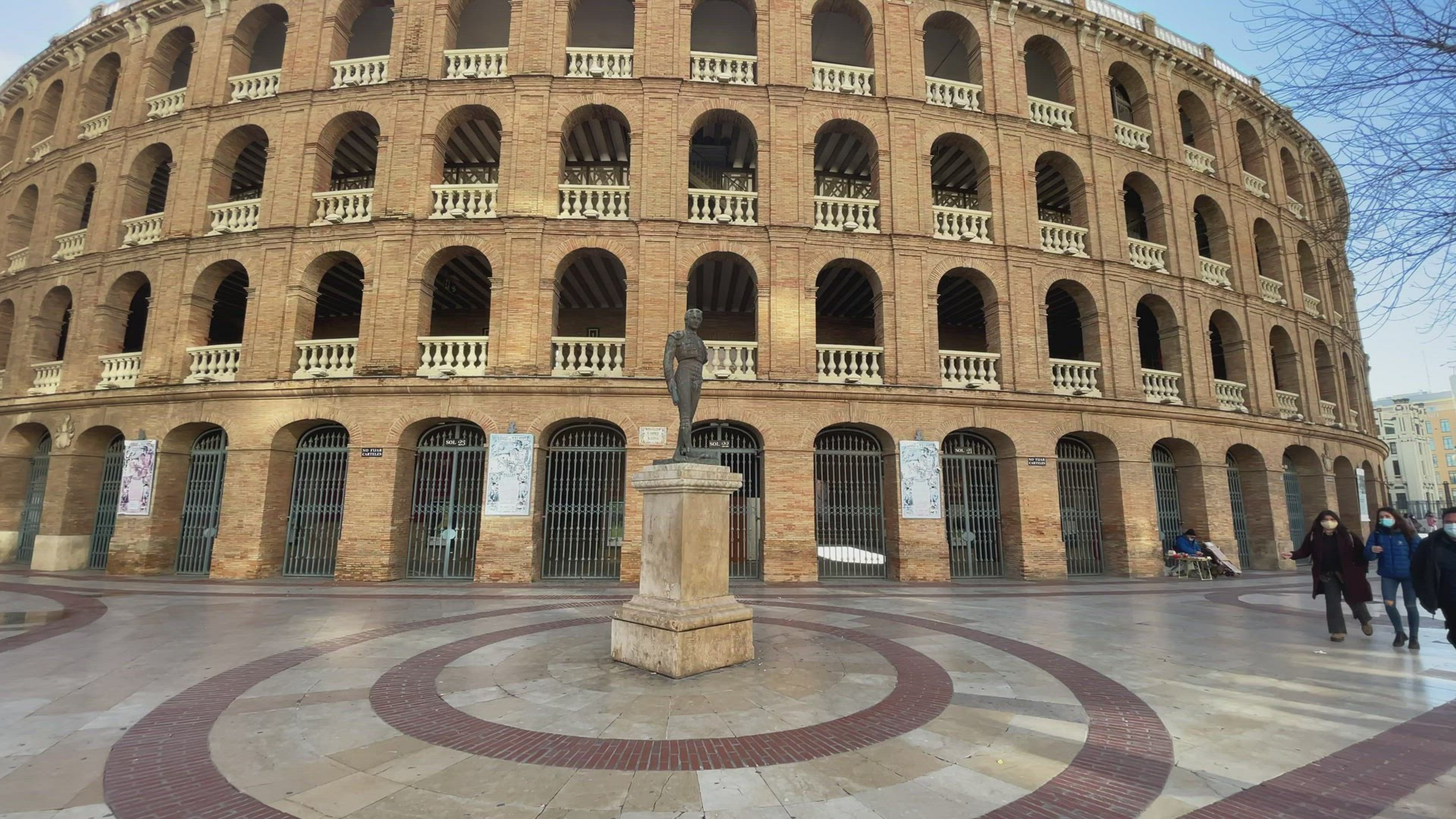 Statue of Toreador Manolo Montoliu against Plaza de Toros de Valencia