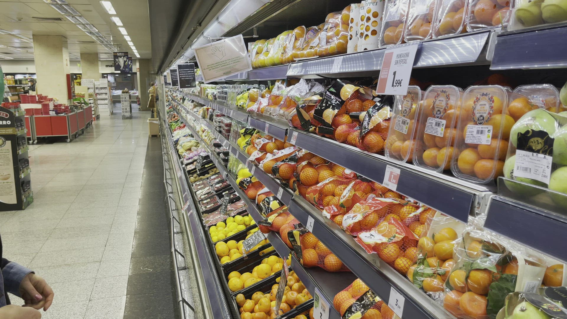 Young woman buying fruits in shop during pandemic