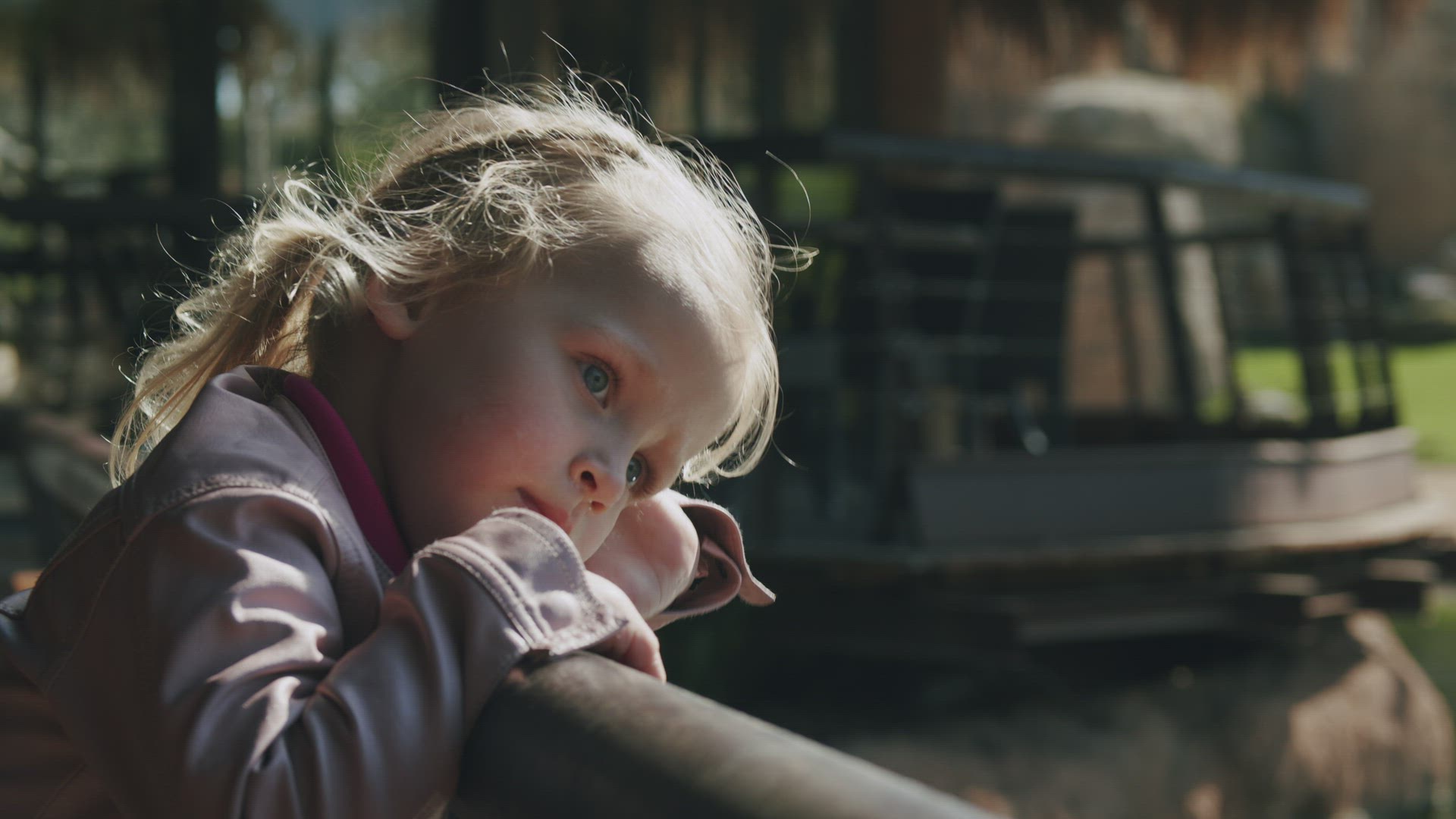Portrait of a little girl watching something from the bridge