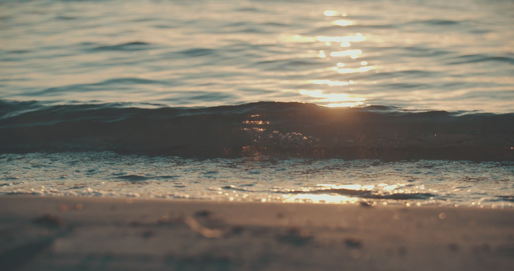 small wave breaking ocean beach sunset slowmotion 4k