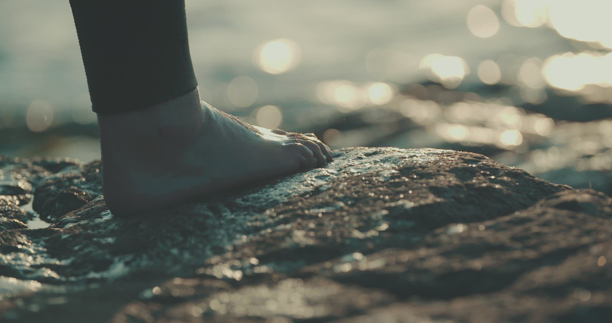 swimmer on rock deatail foot water dripping slowmotion sunset 4k