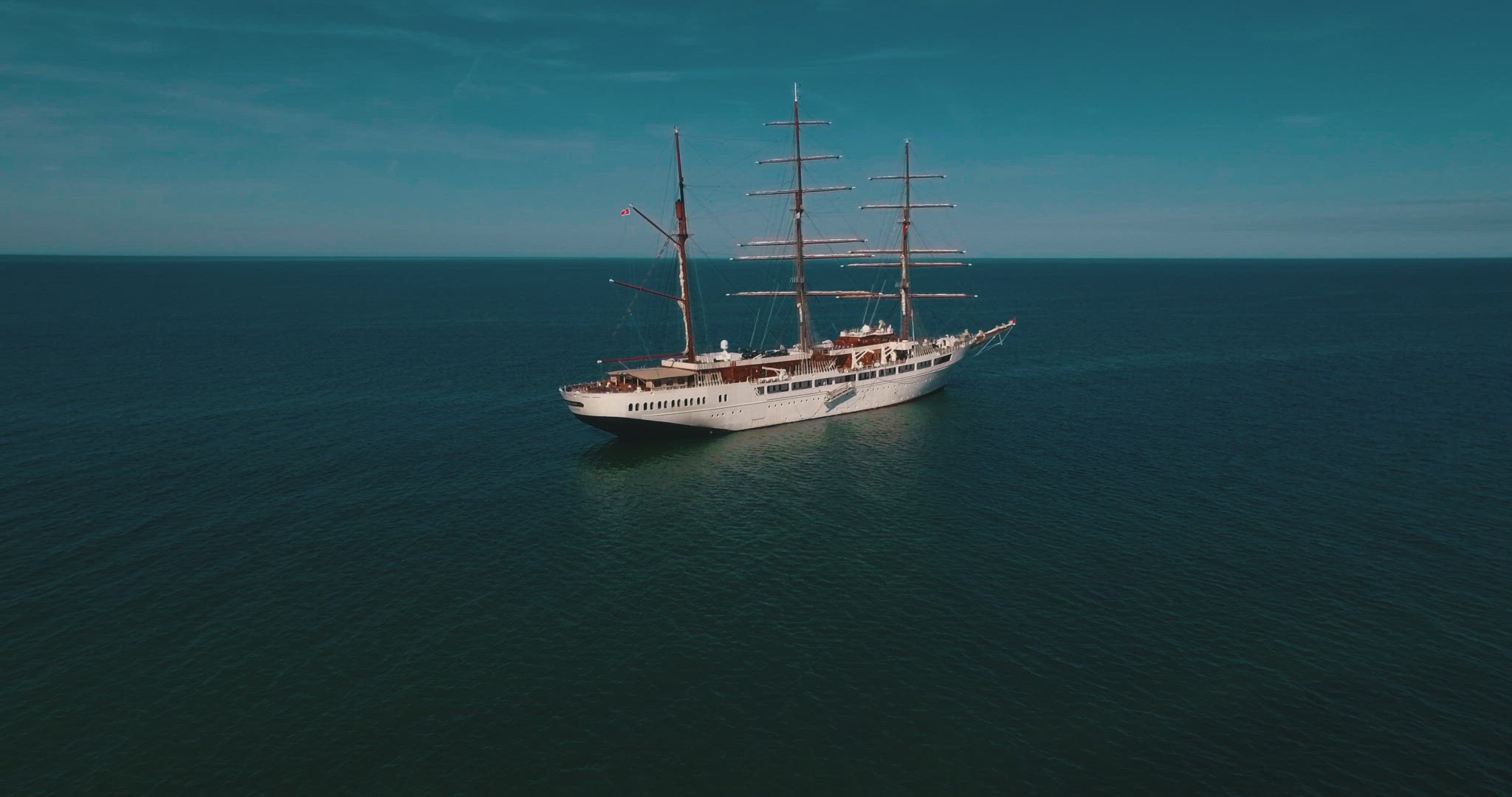 flyover big sailboad aerial ocean summer sun water sail 4k