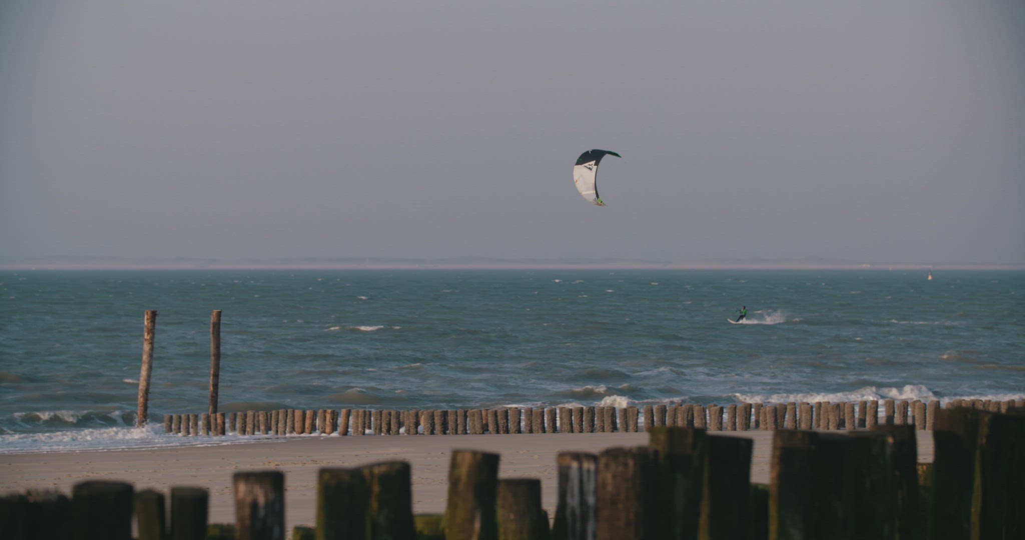 kitesurfer beach wideshot wood pines 4k