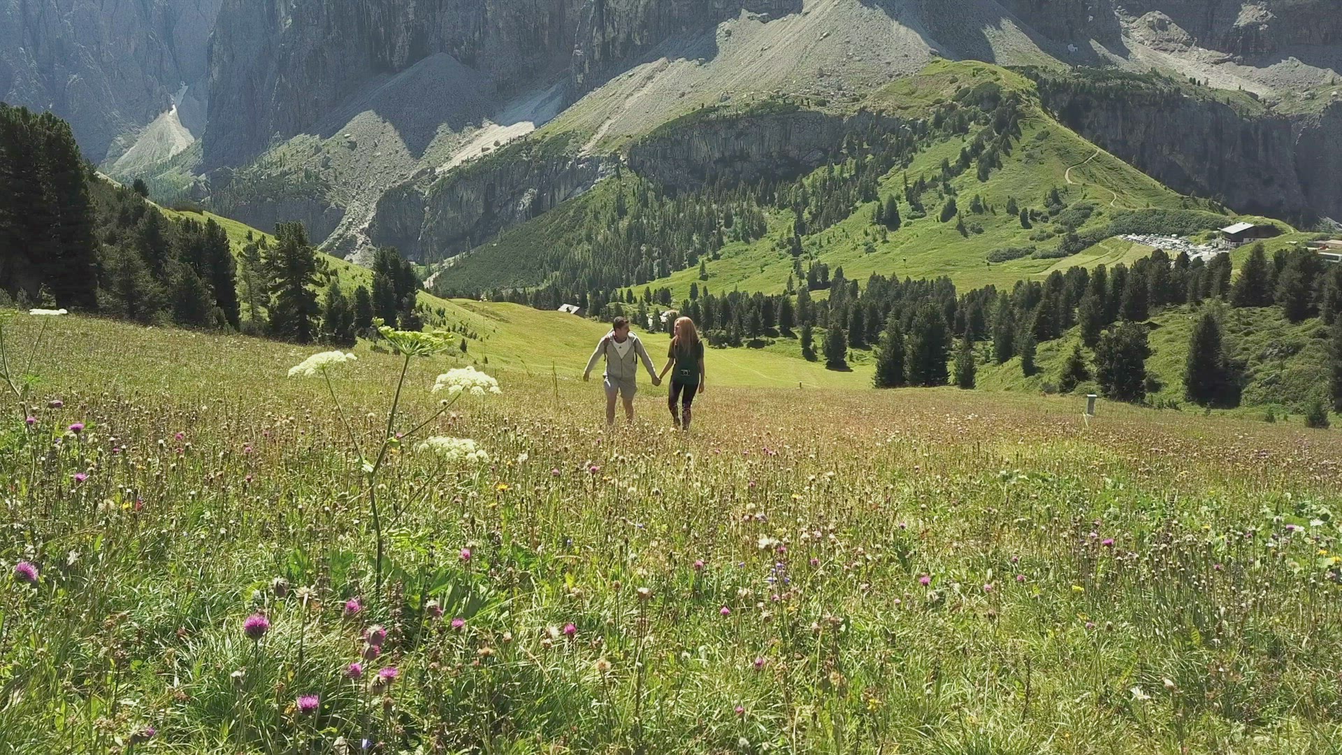 Man and woman hiking in mountain landscape, Alta Badia, Italy