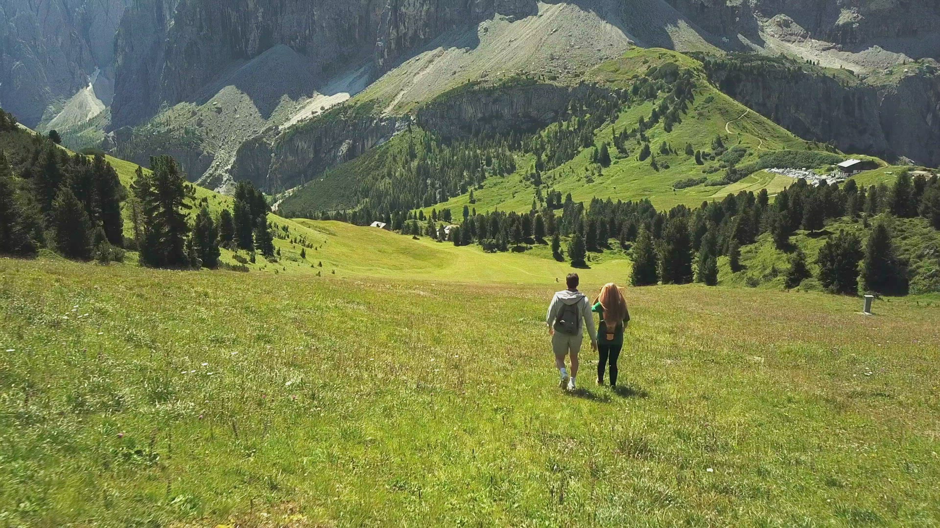 Man and woman hiking in mountain landscape, Alta Badia, Italy