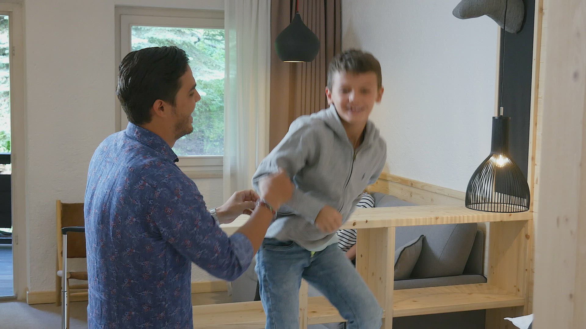 Father playing with son (8-9) in hotel room, Alta Badia, Italy