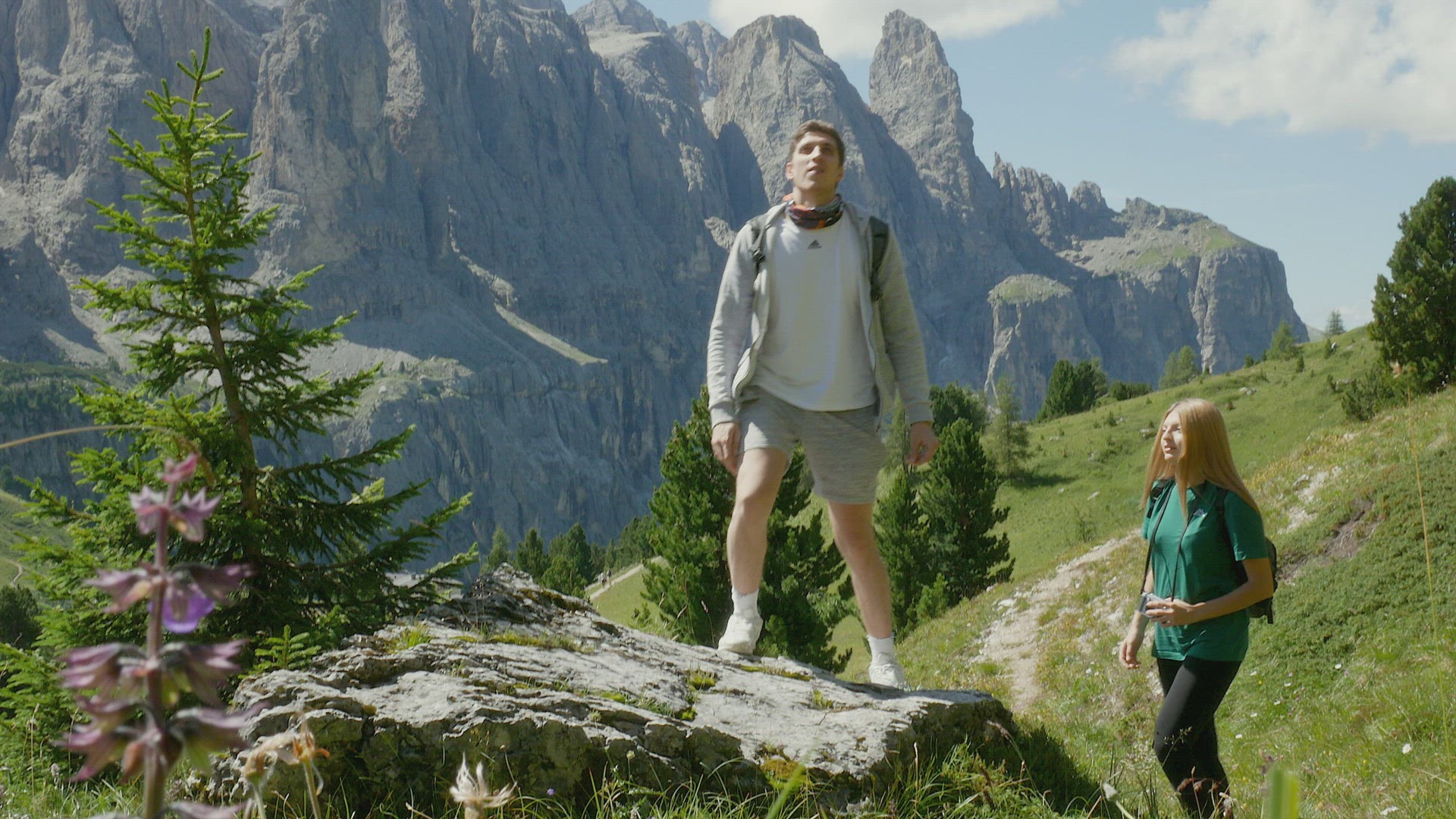 Two people hiking in mountain landscape, Alta Badia, Italy