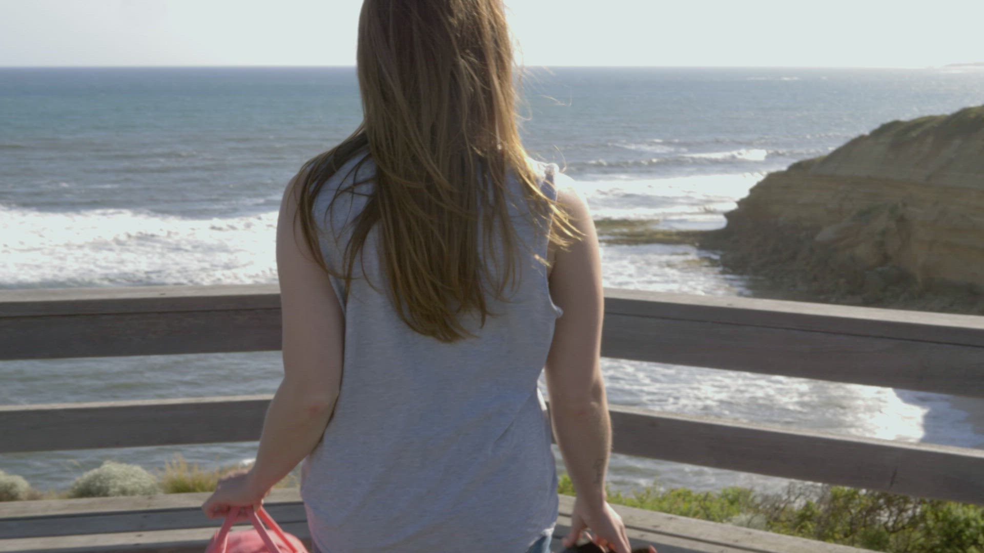 Rear view of young woman looking at sea, Victoria , Australia