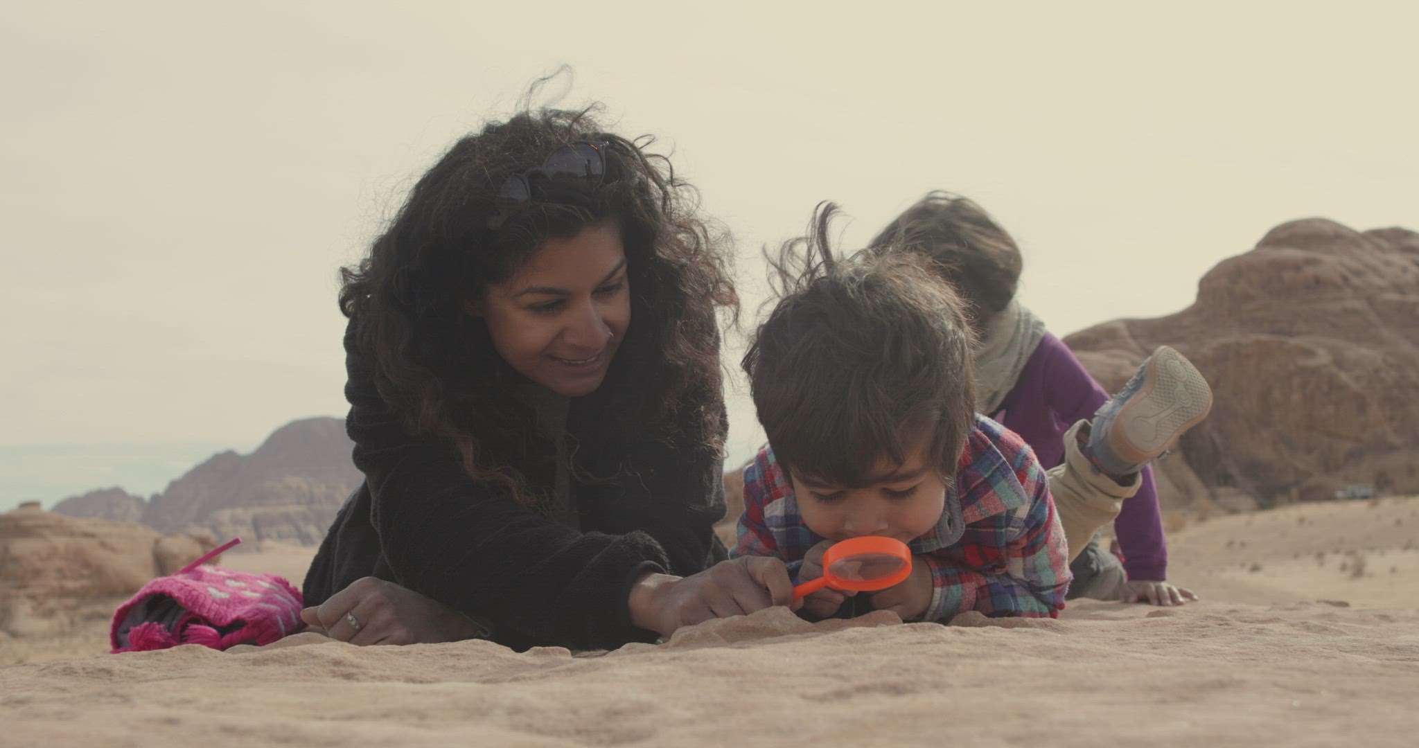 Mother playing with children in Wadi Rum Desert, Jordan