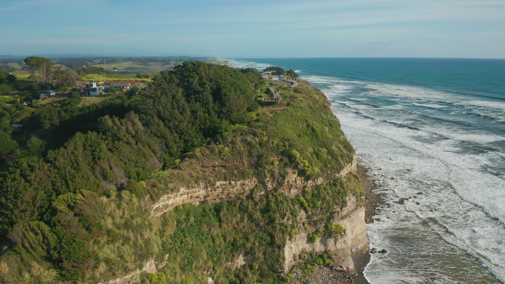 Aerial dolly shot along a steep cliff on the coast line of Puerto Saavedra