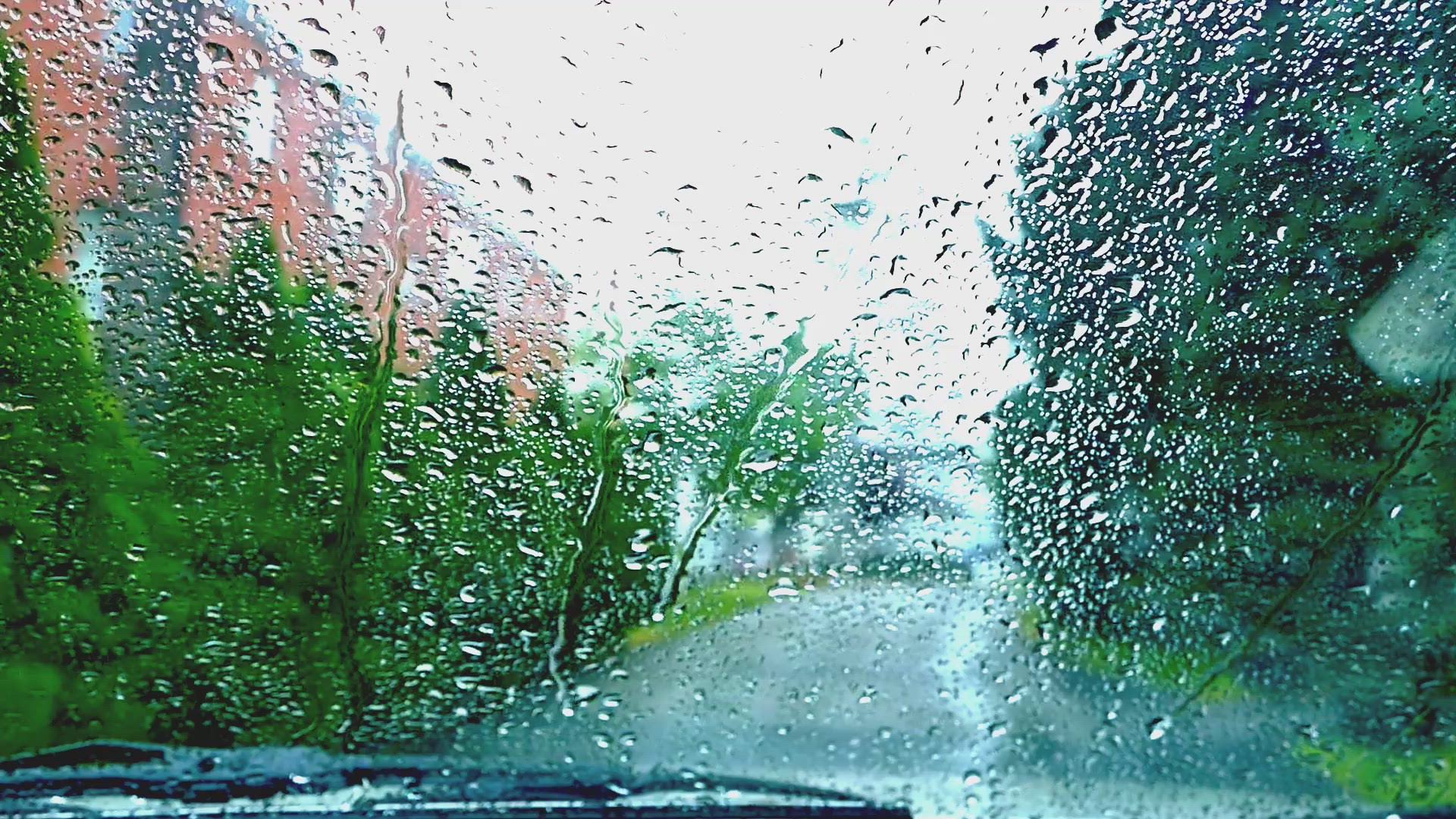 View from inside car at rainy day with rain drops