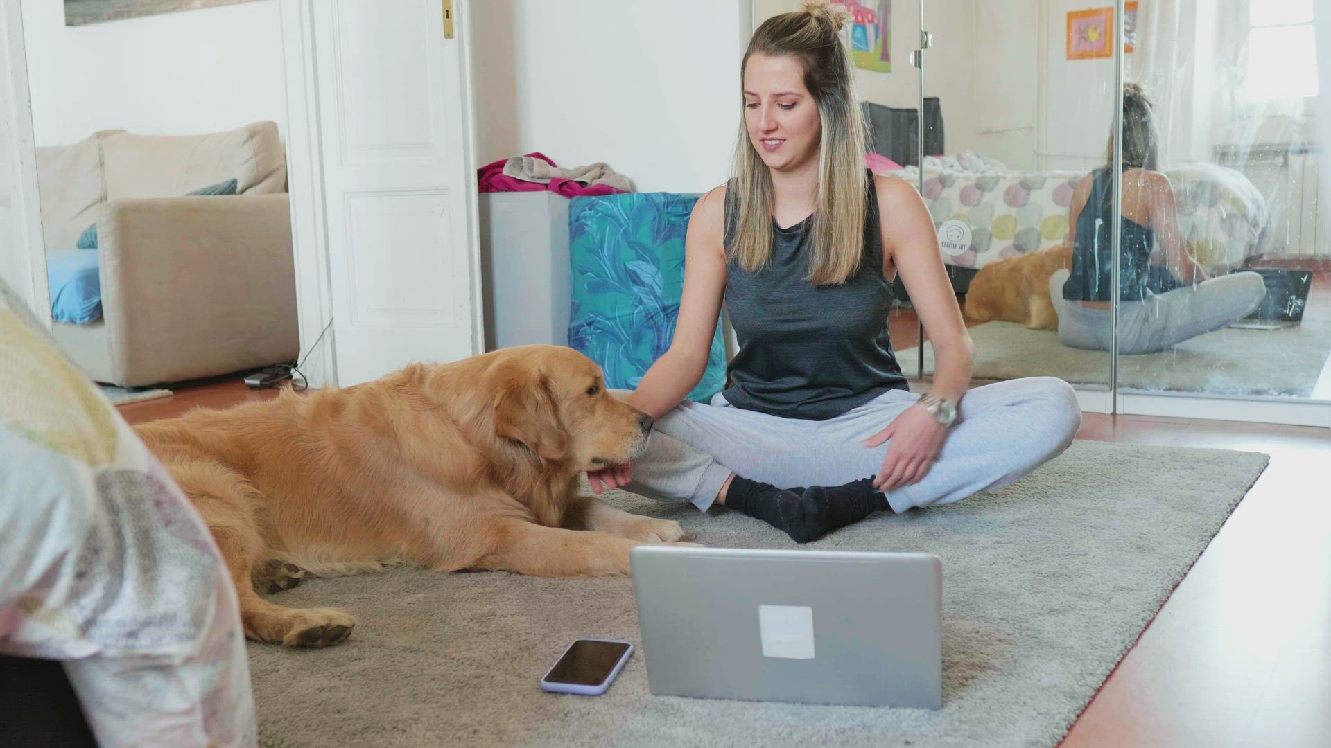 Golden retriever assisting woman meditating in front of laptop, Milan, Italy