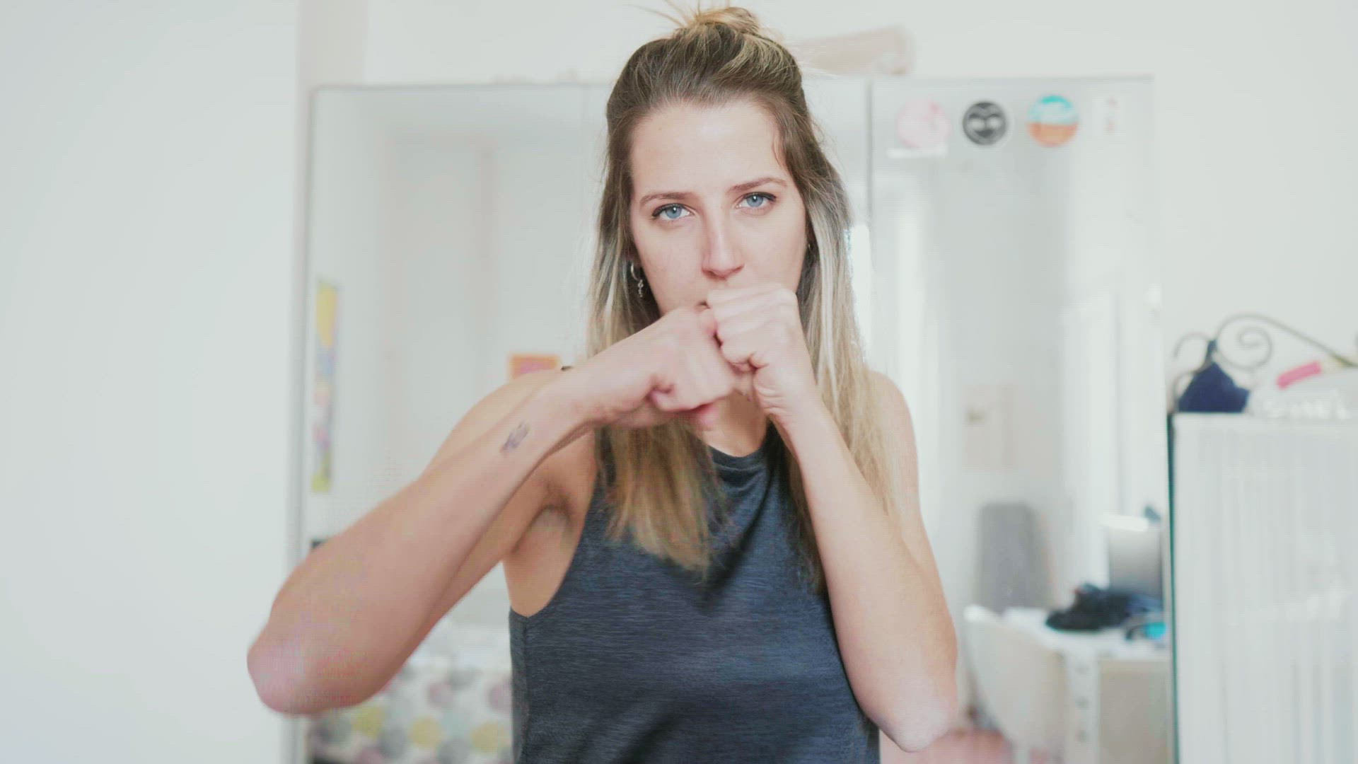 Young woman practicing box at home, Milan, Italy