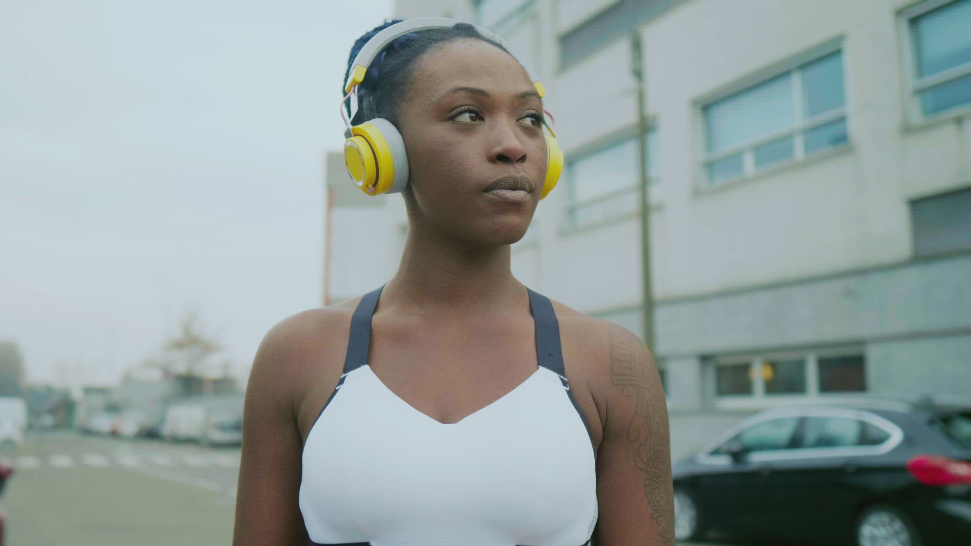 Young woman with headphones in city, Milan, Italy