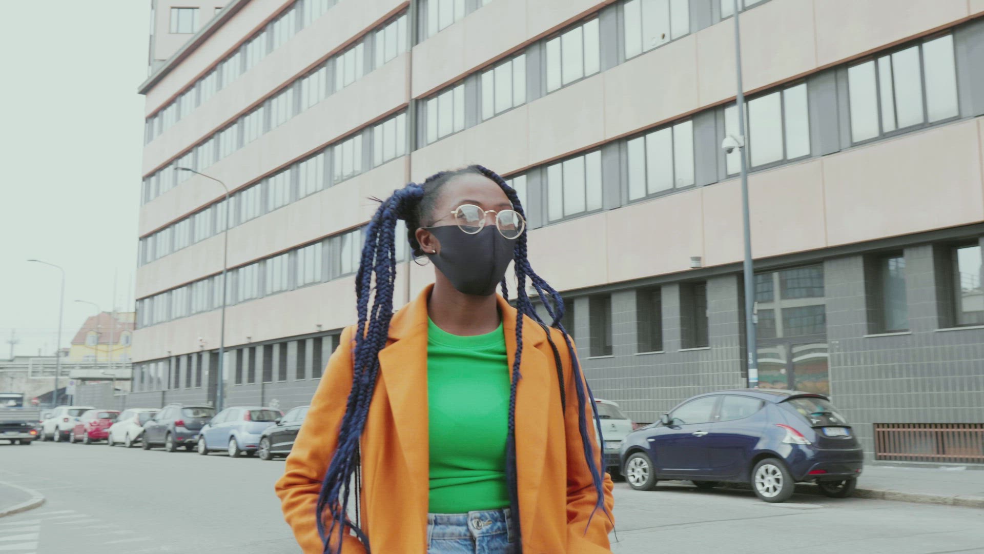 Woman with long black braids wearing face mask in city, Milan, Italy
