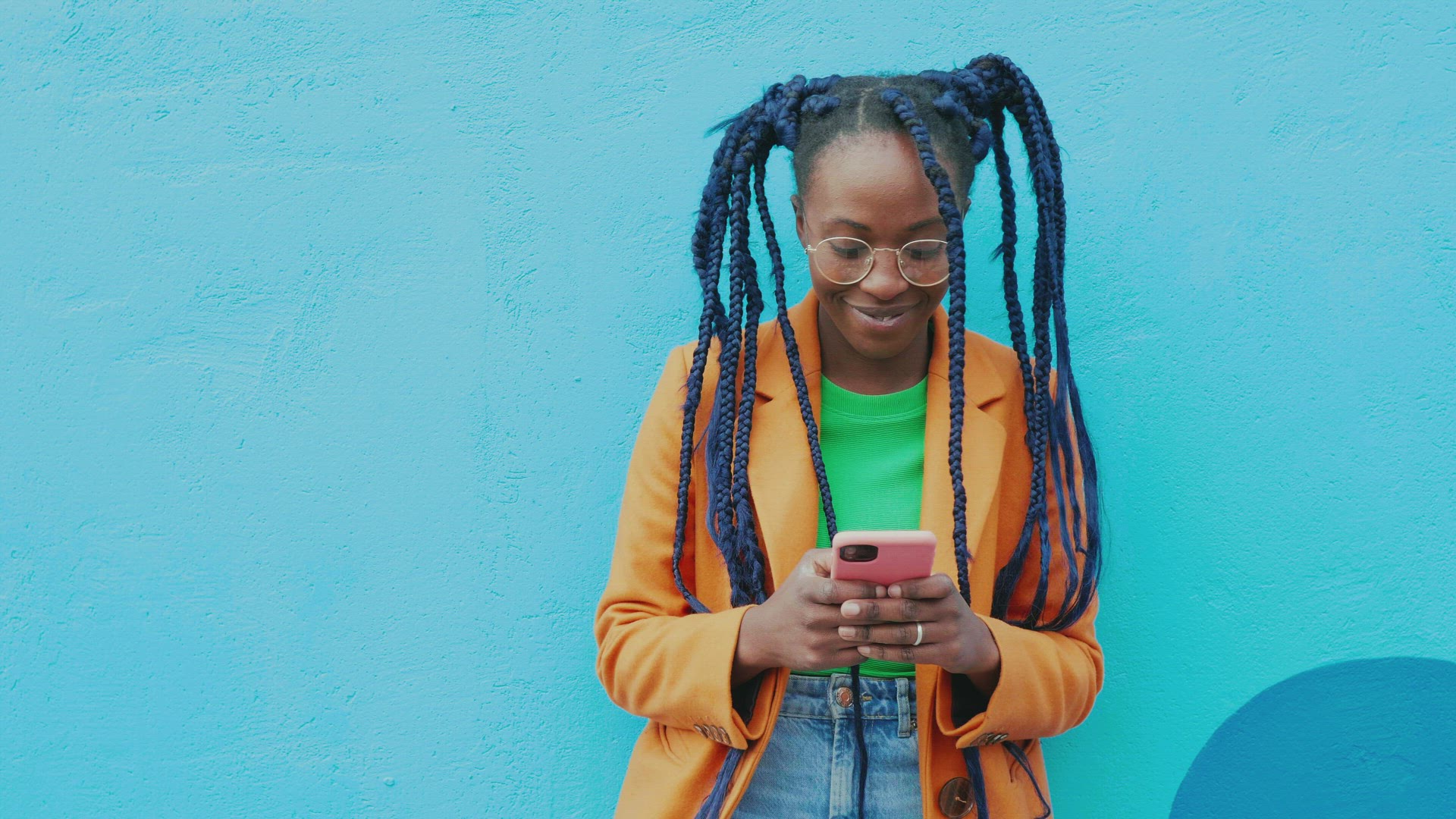 Portrait of woman with long black braids holding smart phone, Milan, Italy