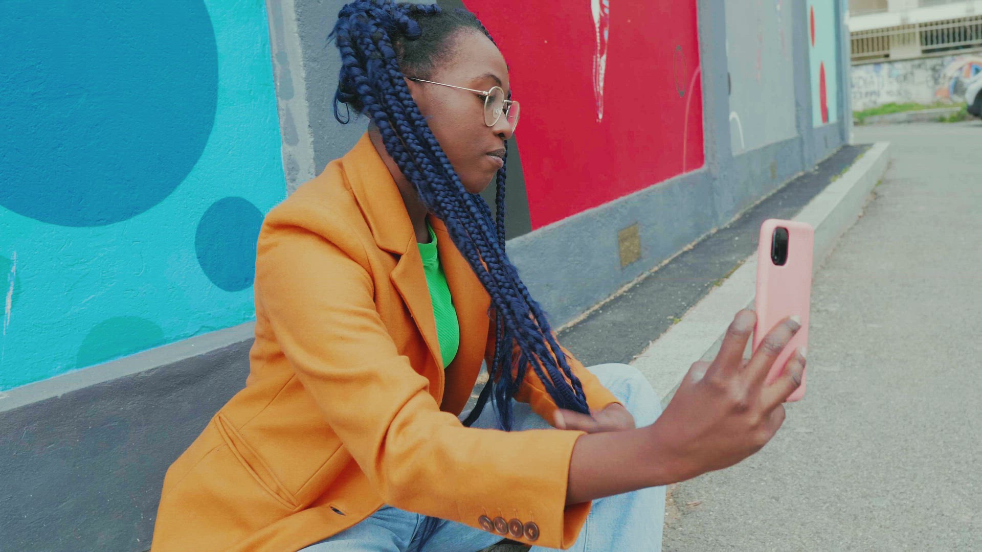Young woman with long black braids taking selfie in city, Milan, Italy