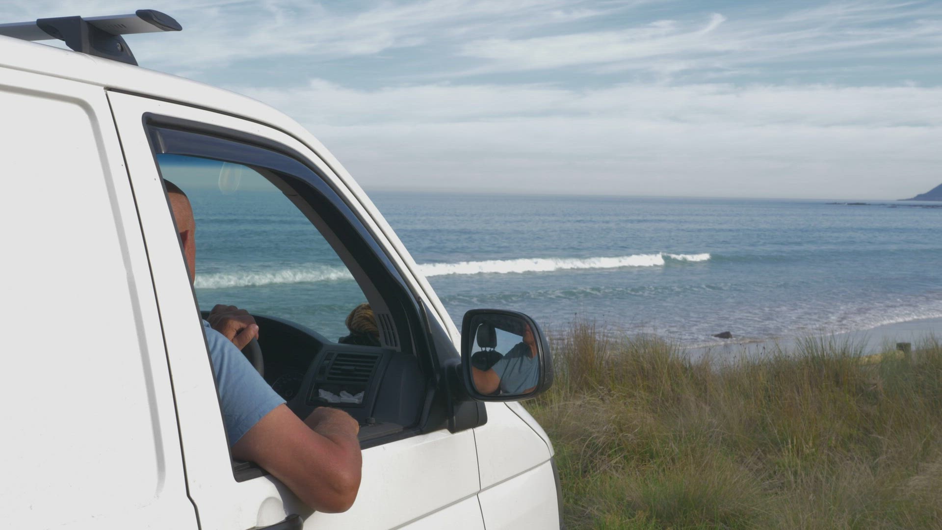 Man in mini van at seashore, Lorne, Victoria, Australia
