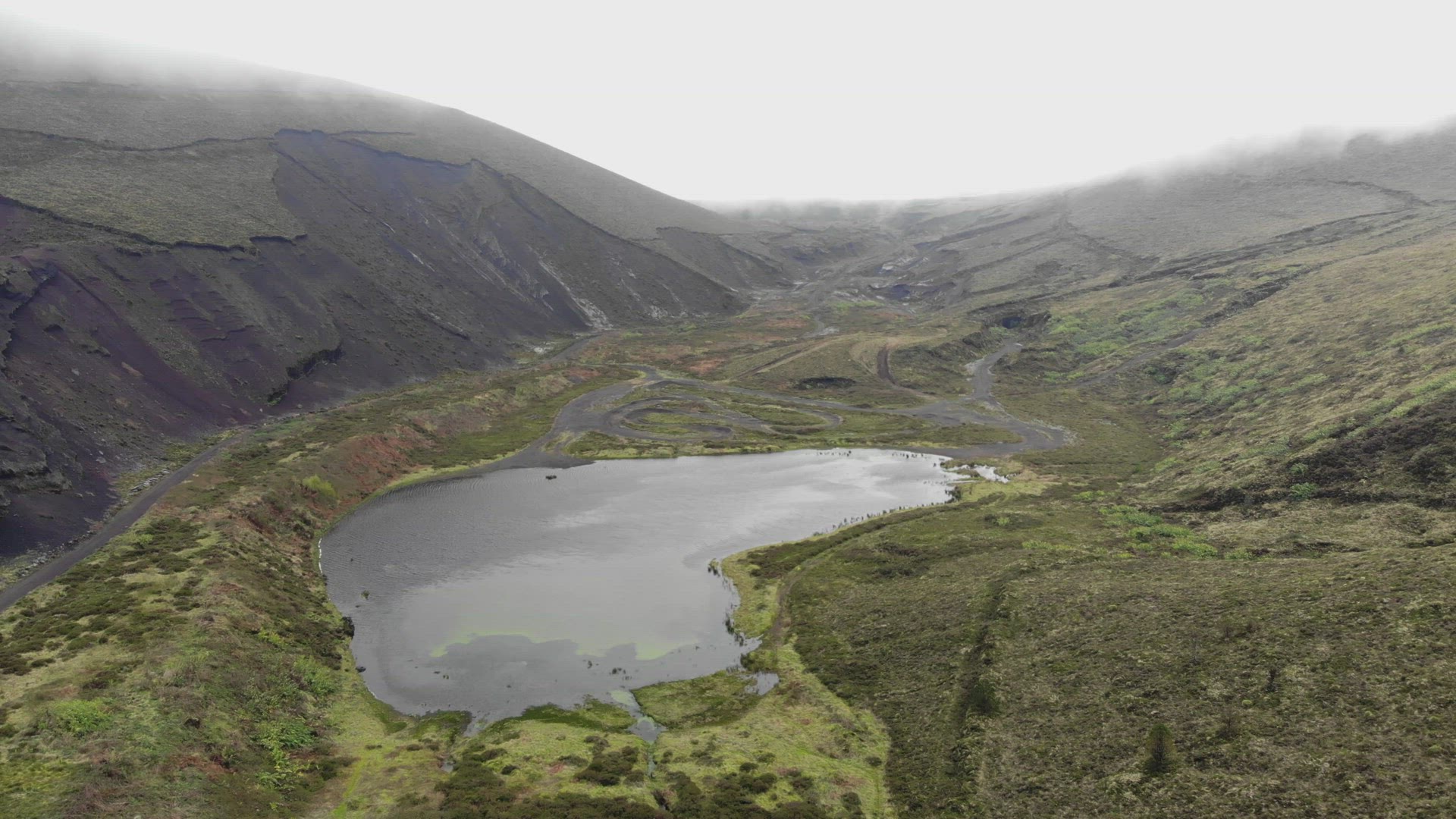 Lagoa do Peixe, one of the smallest lagoons in São Miguel Island, Azores - Aerial pull out fly-over