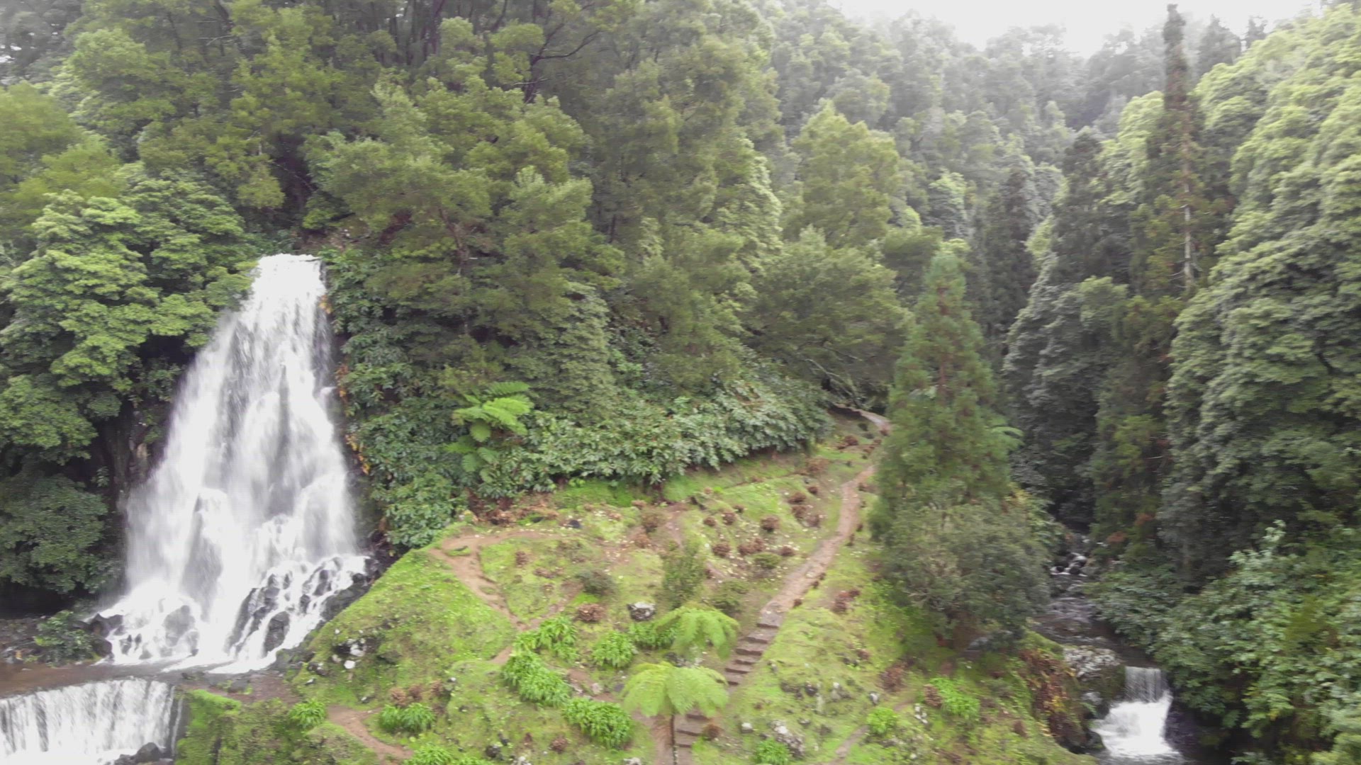 Beautiful waterfall and cascade surrounded by luxuriant vegetation , Azores, Portugal	