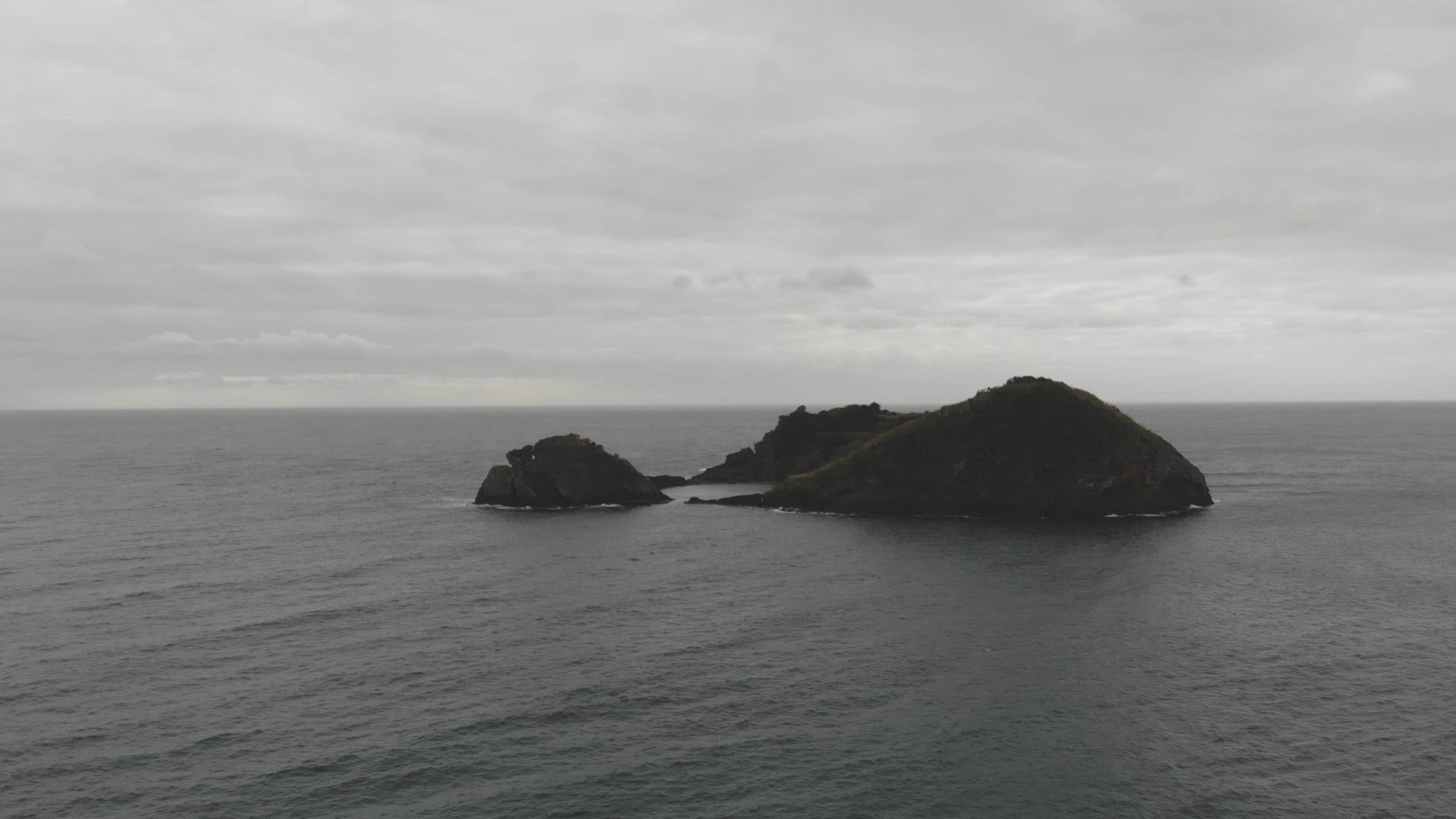 Aerial, 4k, drone footage of coastal reef island just off the shoreline of Azores, Portugal.