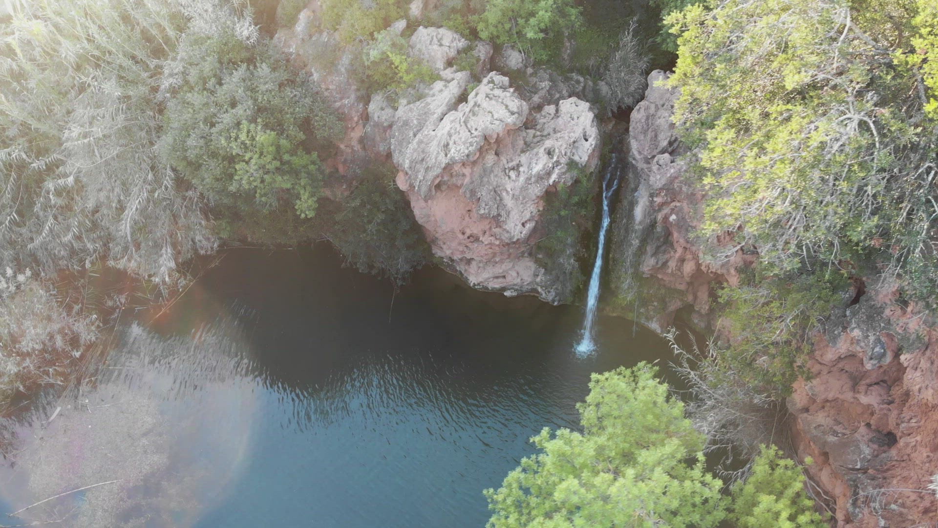 Waterfall of Pego do Inferno at dusk in Tavira, Algarve, Portugal - High angle Orbit Aerial