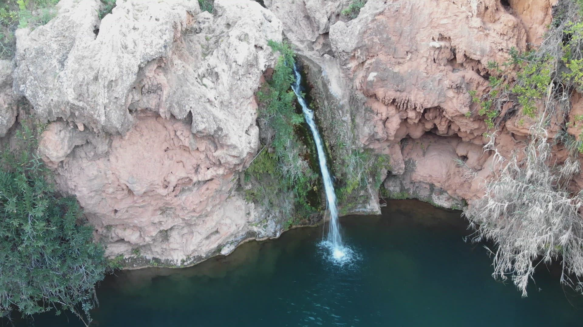 Small waterfall of Pego do Inferno in Santo Estêvão, in Tavira, Algarve, Portugal - Static Aerial