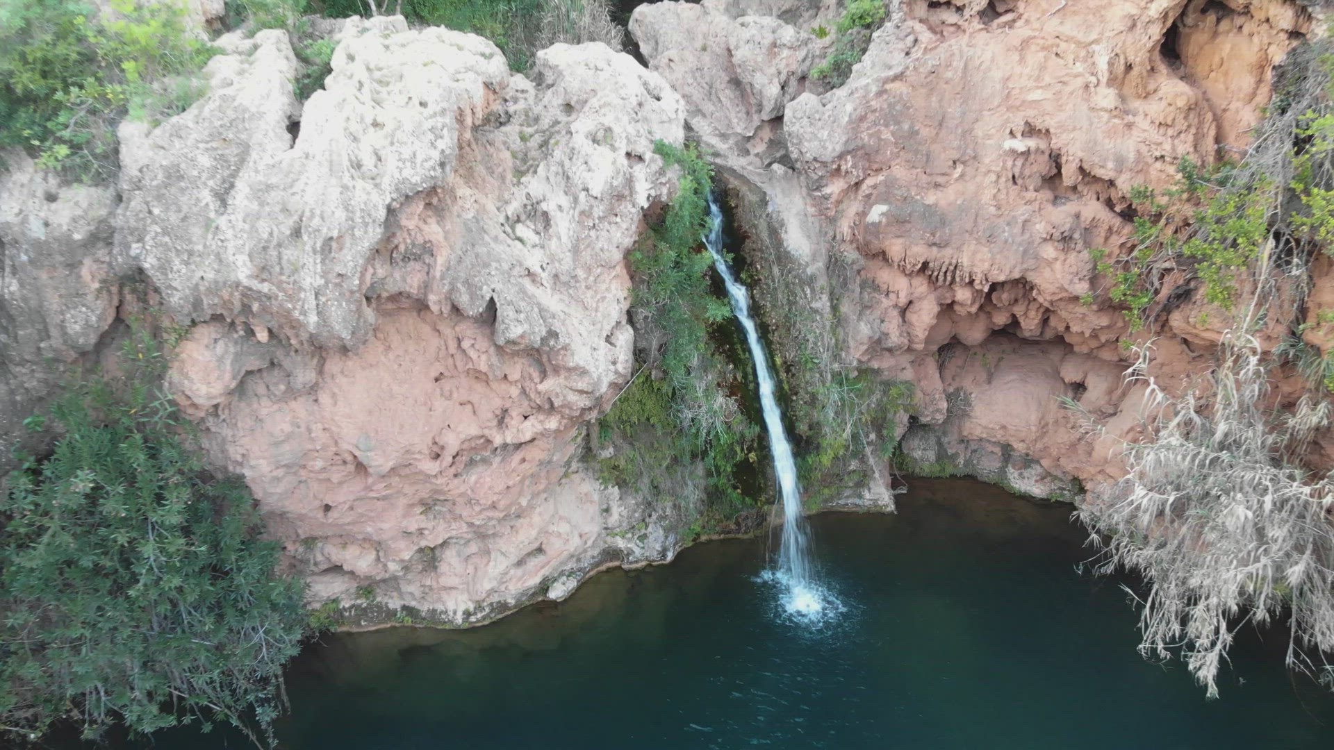 Pego do Inferno,  small waterfall in Santo Estevao, Tavira, Algarve. Aerial dolly out 