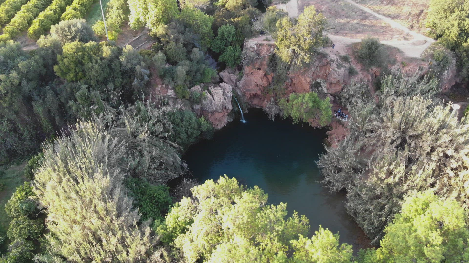 Pego do Inferno hidden lake and waterfall in Tavira, Algarve, Portugal - Survey Orbit Aerial shot