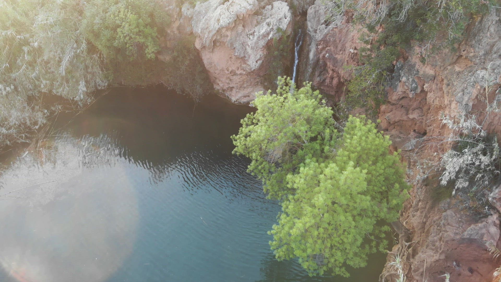 Pego do Inferno waterfall, Tavira, Algarve. Aerial with lens flare 