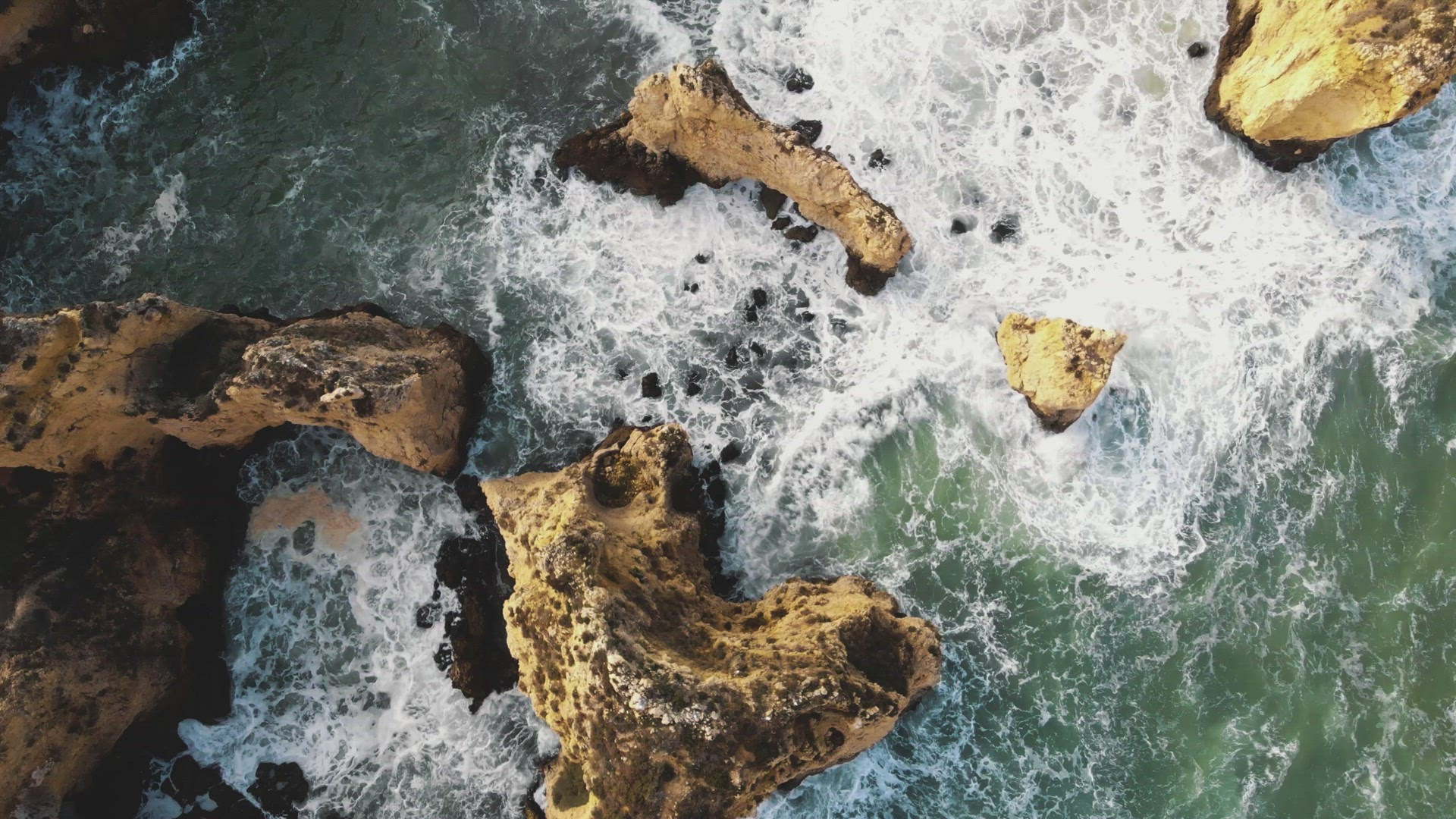 Bird's eye view of Algarve rocky cliffs and rugged coastline, Ponta da Piedade, Lagos Portugal - Aer