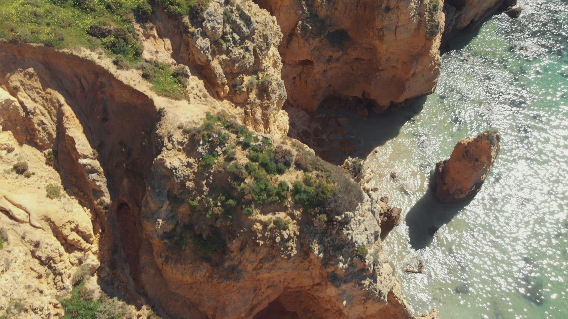 Top view of eroded cliff scarps coastline in Ponta da Piedade, Lagos, Algarve, Portugal - Aerial Bir