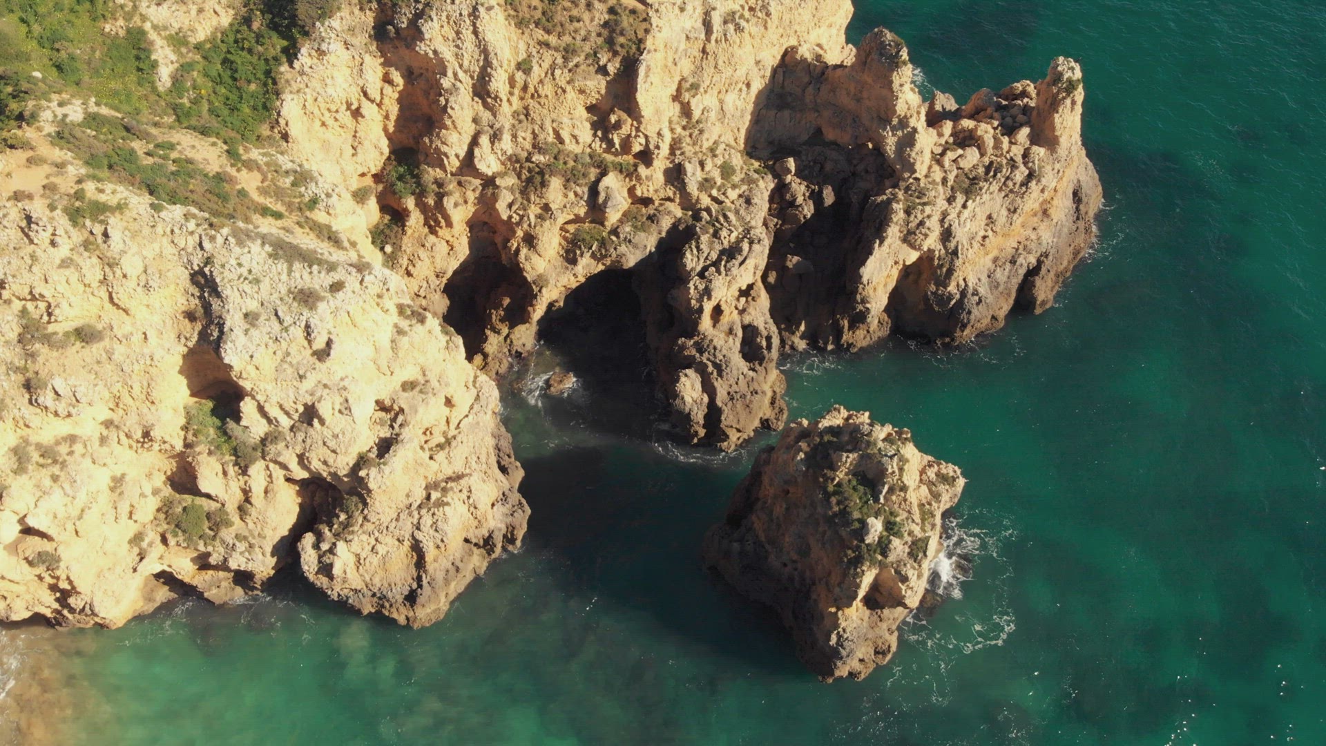 Rocky Formations and erosion Grottos in Ponta da Piedade Lagos Algarve - Aerial Top view Rotation sh
