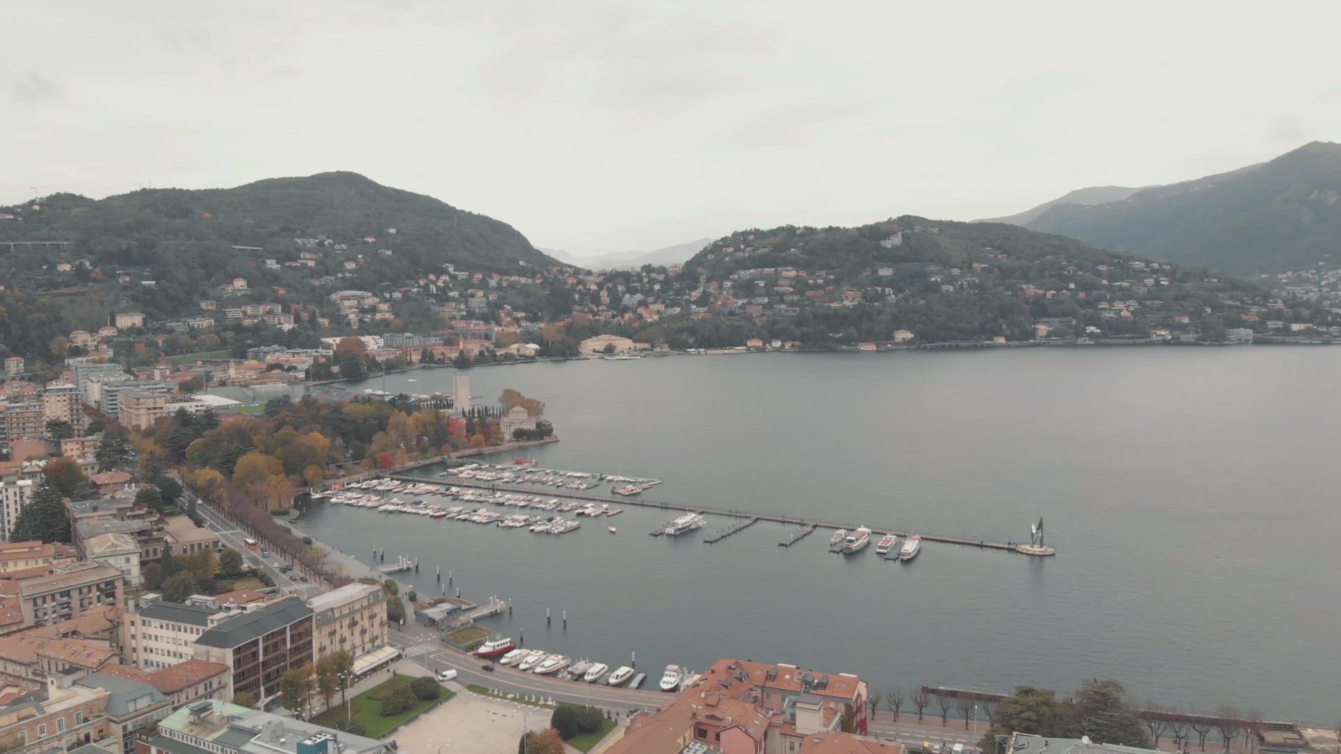 Yachts and boats moored at Lake Como marina, Lombardy. Aerial establisher	