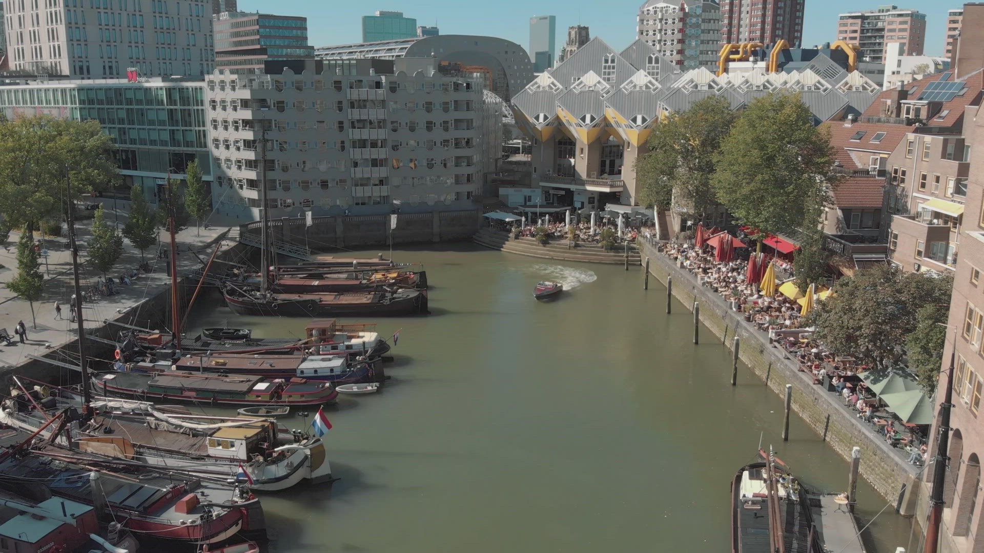Aerial footage of a fly over of the harbor of Rotterdam, Netherlands where several boats and barges 
